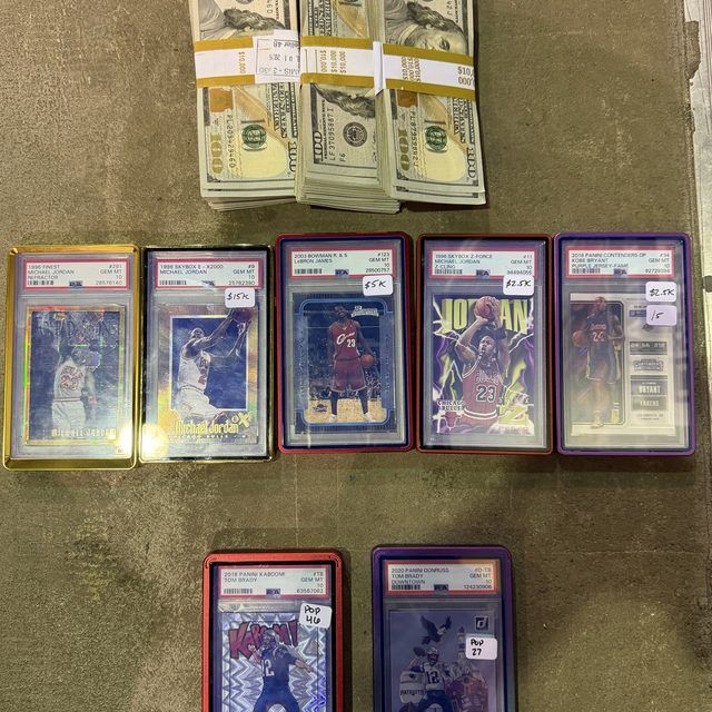 Three banded stacks of cash beside seven PSA 10 slabs including Jordan refractors, a LeBron rookie, a Kobe Purple Jersey and two Tom Brady cards, from the $200k trade at The National