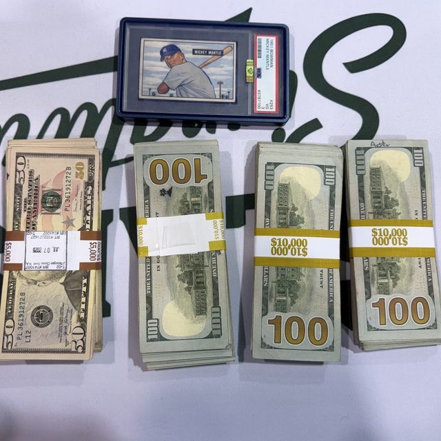 A 1951 Bowman Mickey Mantle slab beside four banded stacks of cash