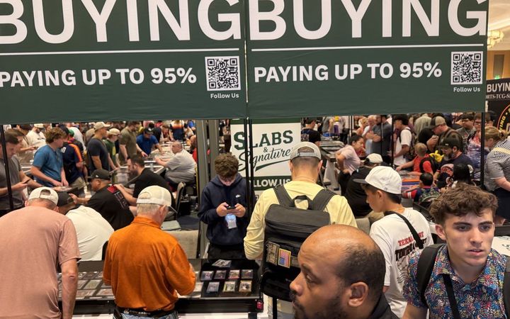 Crowded Slabs & Signatures buying booth under BUYING and PAYING UP TO 95% banners at the Conroe Card Show, July 2026