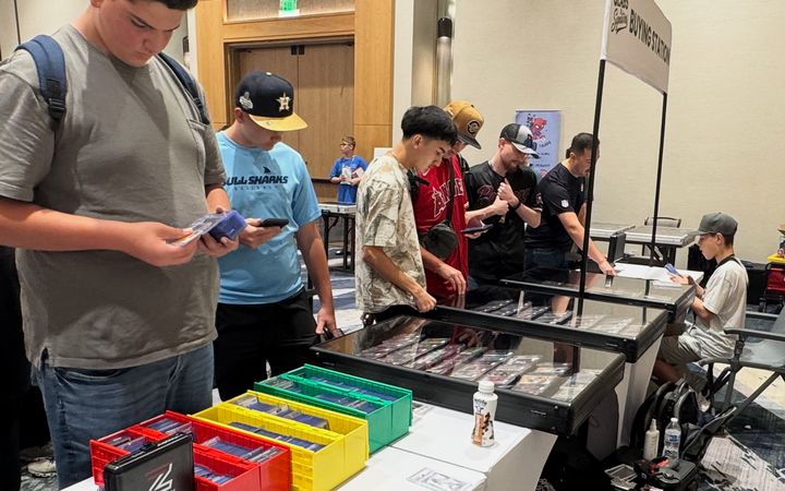 Collectors lined up at the Slabs & Signatures Buying Station and display cases at the Conroe Card Show, September 2025