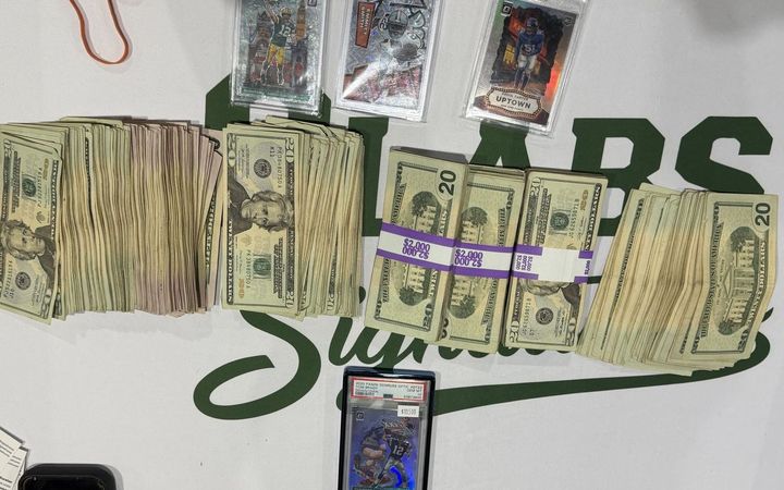 Stacks of cash and graded cards from sales at the H-Town Card Show, March 2026