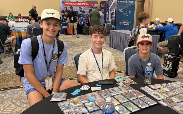 Graded cards spread across the Slabs & Signatures table in the Collectors Lounge at the 2026 National Sports Collectors Convention in Rosemont, Illinois