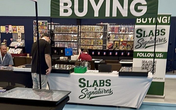 Slabs & Signatures buying booth with banners at The Wood Card Show, February 2026